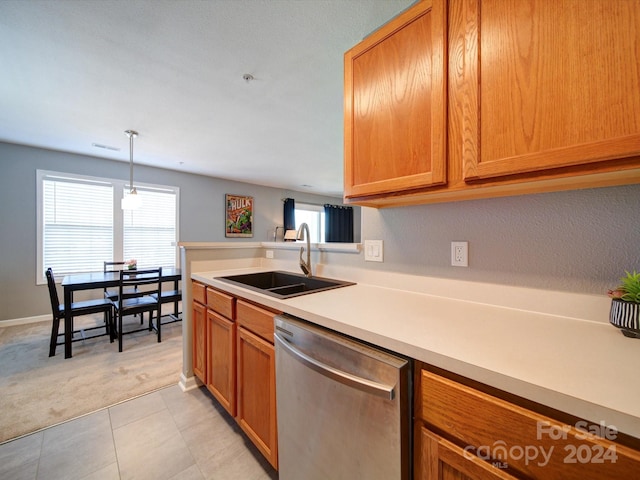 kitchen with sink, hanging light fixtures, dishwasher, and light carpet