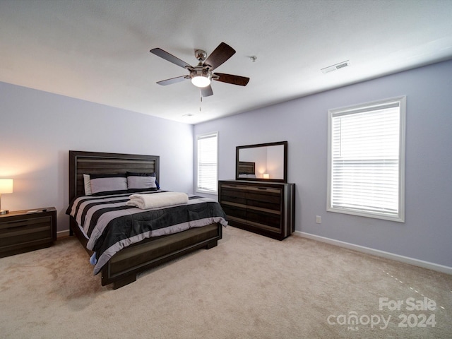 bedroom featuring light colored carpet and ceiling fan