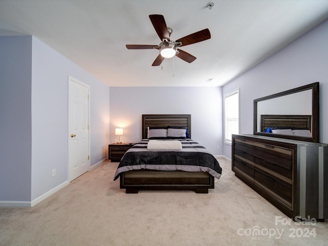 bedroom featuring light carpet and ceiling fan