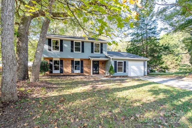 view of front of property with a front yard and a garage