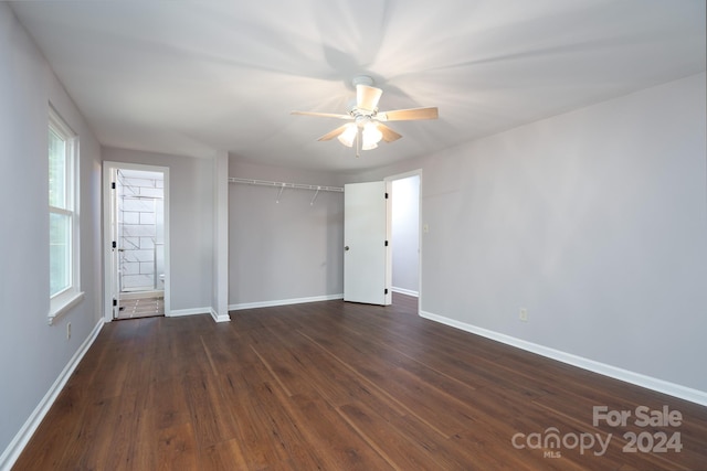 empty room featuring dark wood-type flooring and ceiling fan