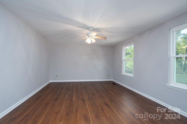 spare room featuring ceiling fan and dark hardwood / wood-style floors