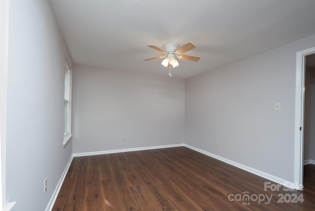 spare room with ceiling fan and dark hardwood / wood-style floors