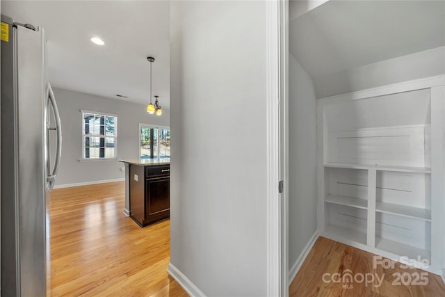 hallway with light hardwood / wood-style flooring