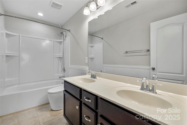 full bathroom featuring vanity, tile patterned floors, washtub / shower combination, and toilet