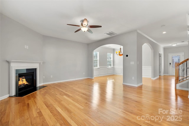 unfurnished living room featuring ceiling fan and light hardwood / wood-style floors