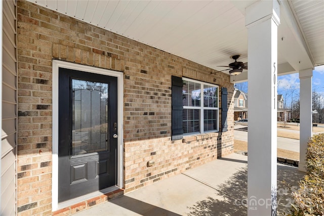 entrance to property featuring covered porch and ceiling fan