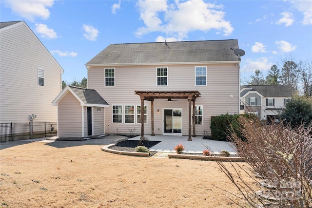 back of property with an outbuilding, a pergola, and a patio