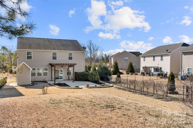 back of property featuring a patio area and a pergola