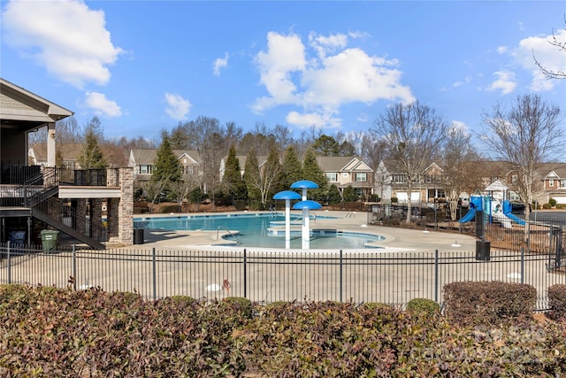 view of pool featuring a playground