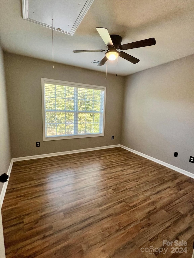 unfurnished room featuring ceiling fan and dark hardwood / wood-style flooring