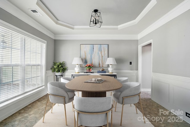 3007 Gambrill Falls Dr, Indian Trail, NC 28079 - dining room with a tray ceiling, wainscoting, and crown molding