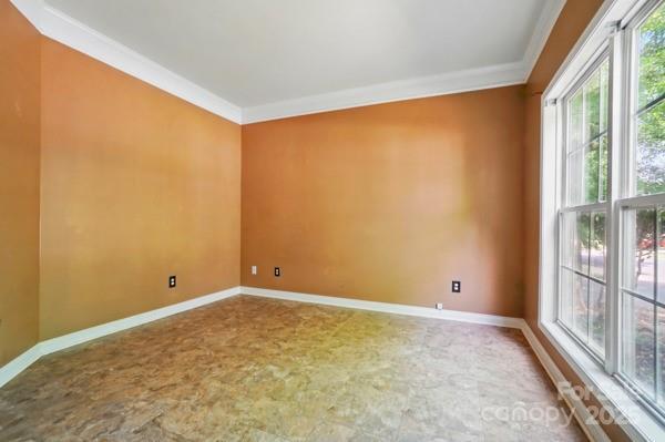 3007 Gambrill Falls Dr, Indian Trail, NC 28079 - spare room with crown molding and baseboards