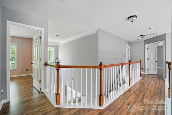 3007 Gambrill Falls Dr, Indian Trail, NC 28079 - hallway with wood finished floors, an upstairs landing, and baseboards