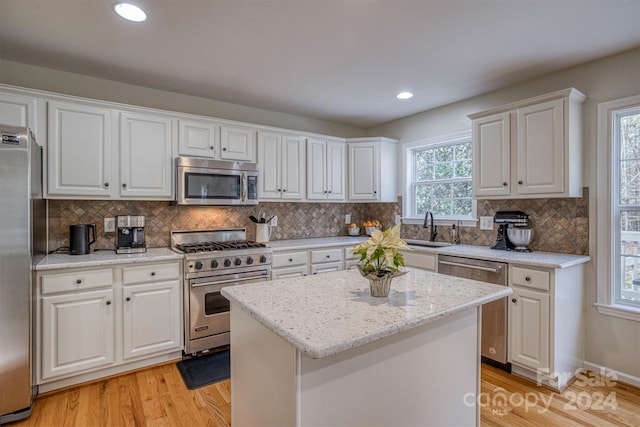 kitchen featuring a center island, stainless steel appliances, and white cabinetry