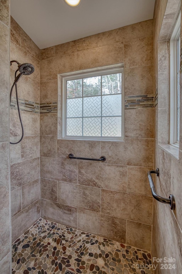 bathroom with a tile shower