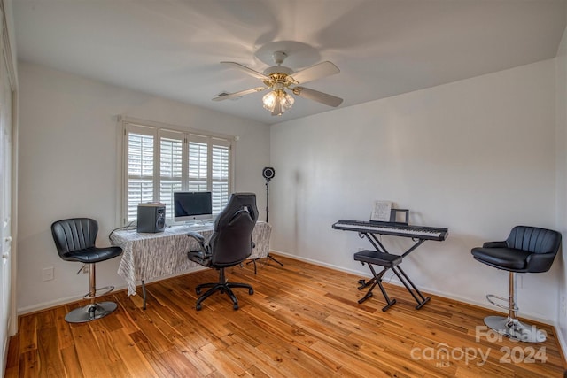 office space featuring ceiling fan and light hardwood / wood-style floors