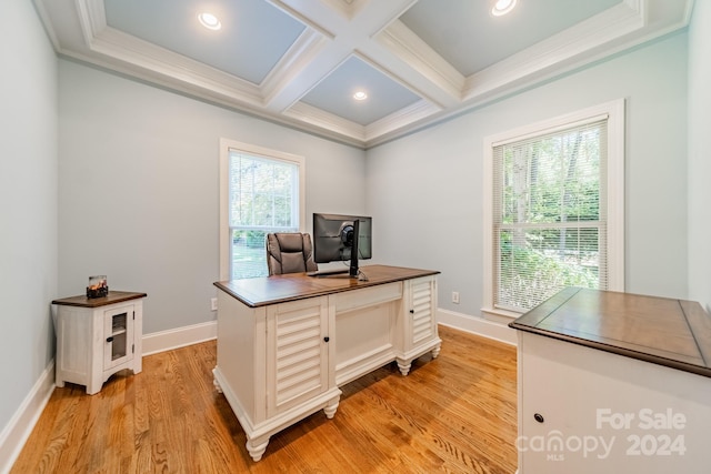 office space with light hardwood / wood-style floors, crown molding, coffered ceiling, and a wealth of natural light