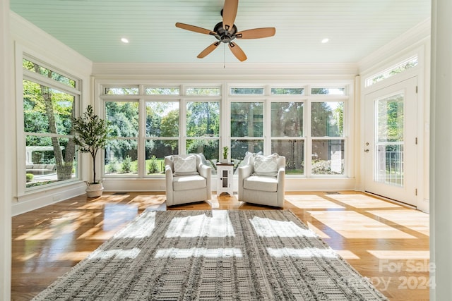 unfurnished sunroom with a healthy amount of sunlight and ceiling fan