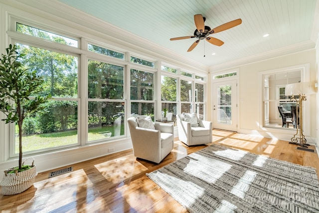 unfurnished sunroom featuring ceiling fan and wooden ceiling