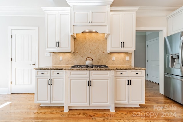 kitchen featuring light stone counters, appliances with stainless steel finishes, light hardwood / wood-style flooring, and white cabinets