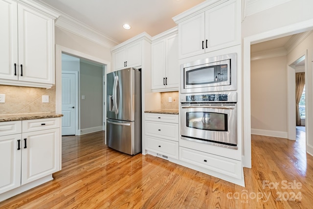 kitchen featuring light hardwood / wood-style floors, stainless steel appliances, and white cabinets