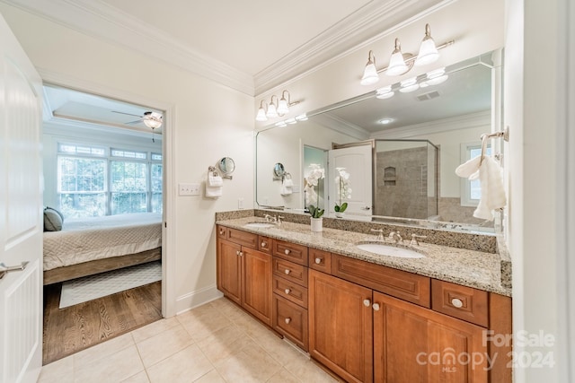 bathroom featuring a shower with shower door, ceiling fan, vanity, crown molding, and tile patterned flooring