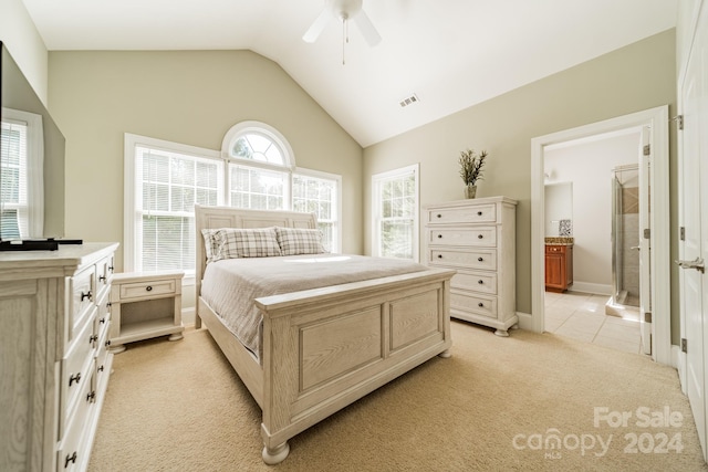 carpeted bedroom featuring connected bathroom, ceiling fan, vaulted ceiling, and multiple windows