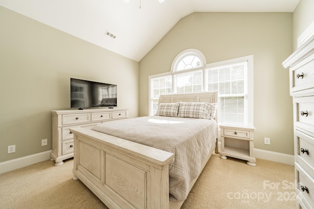 carpeted bedroom with vaulted ceiling