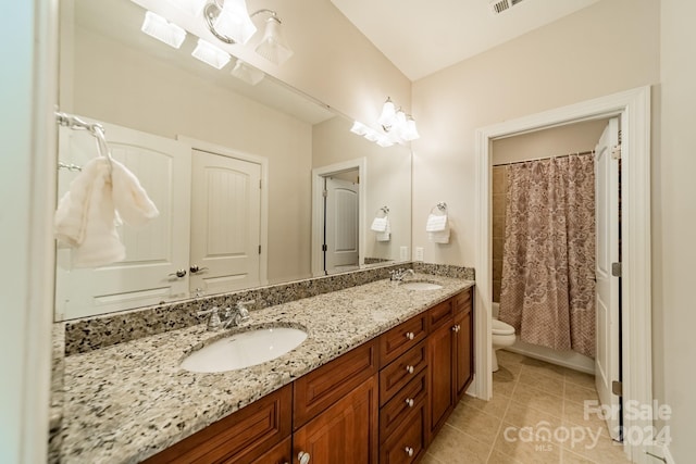 bathroom featuring toilet, a shower with curtain, vanity, and tile patterned flooring