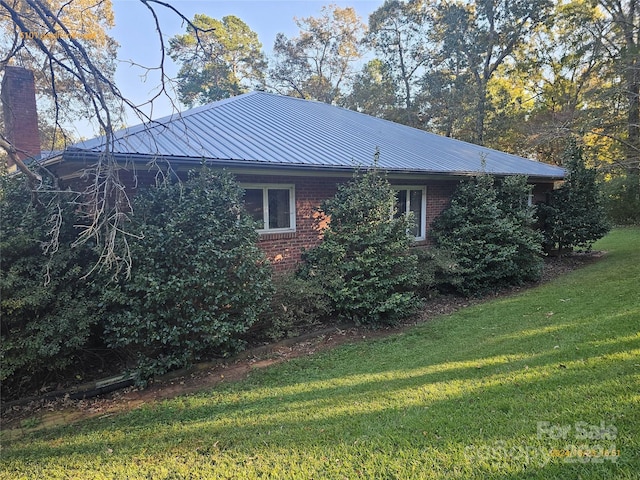 view of property exterior with a lawn