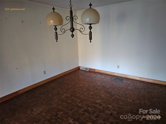 interior space with crown molding, wood walls, and dark parquet flooring