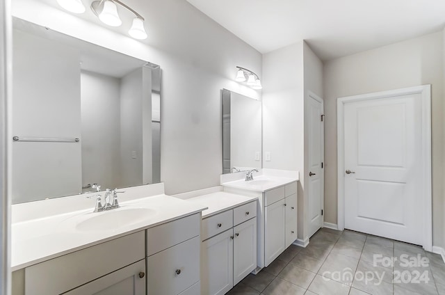 bathroom featuring tile patterned flooring and vanity