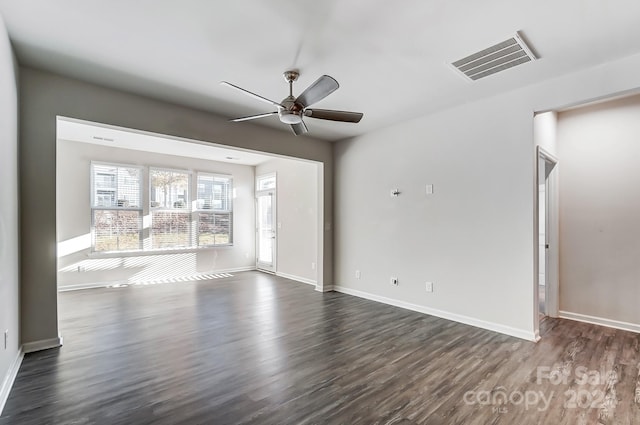 empty room featuring ceiling fan and dark wood-type flooring