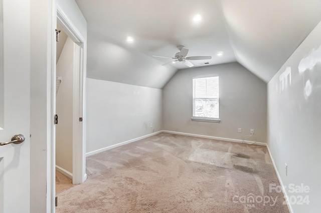 additional living space with ceiling fan, lofted ceiling, and light carpet