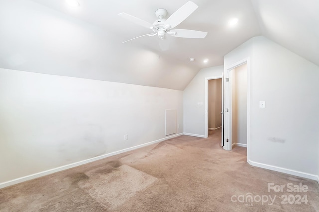 bonus room with ceiling fan, light colored carpet, and vaulted ceiling