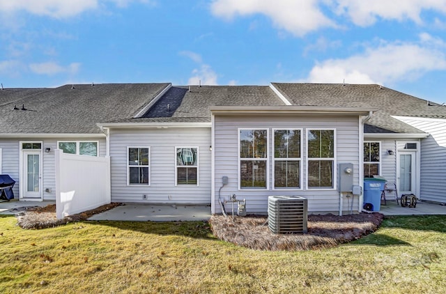 back of house with central air condition unit, a lawn, and a patio