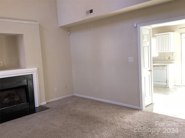 unfurnished living room with light carpet