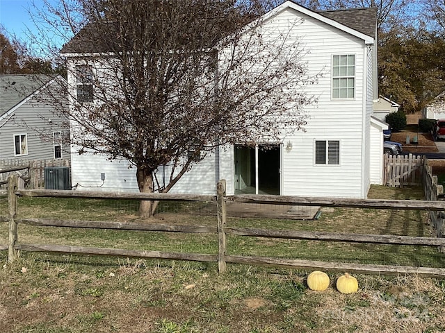 rear view of property featuring central AC