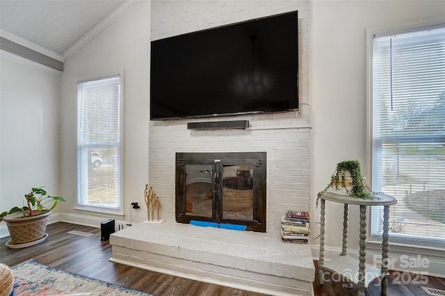 room details with hardwood / wood-style floors, ornamental molding, and a fireplace