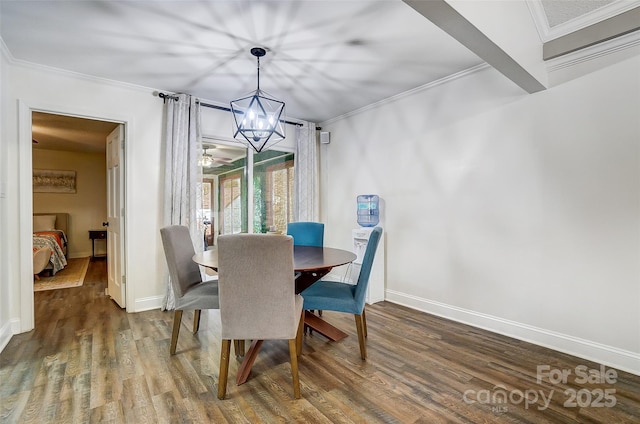 dining room featuring dark hardwood / wood-style flooring, ceiling fan with notable chandelier, and crown molding