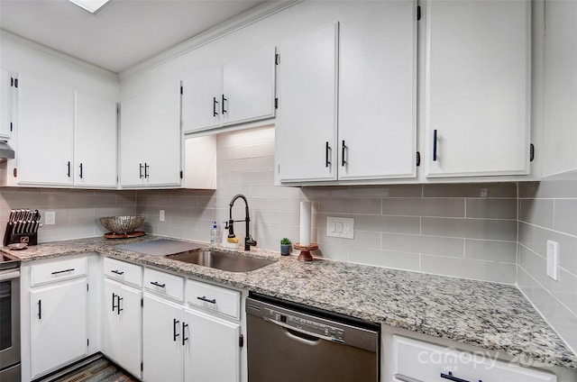 kitchen with backsplash, sink, white cabinetry, and black dishwasher