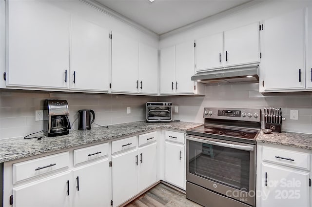 kitchen featuring white cabinets, stainless steel range with electric cooktop, decorative backsplash, light stone counters, and light hardwood / wood-style flooring