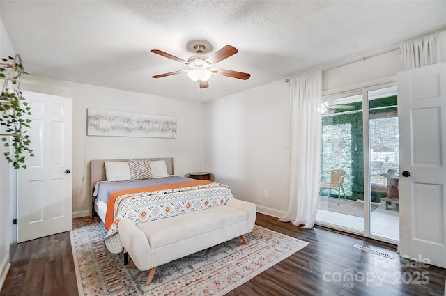 bedroom with dark wood-type flooring, ceiling fan, a textured ceiling, and access to outside