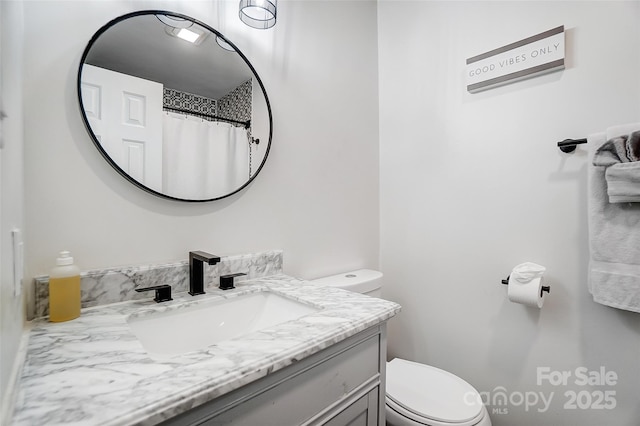 bathroom with toilet and vanity