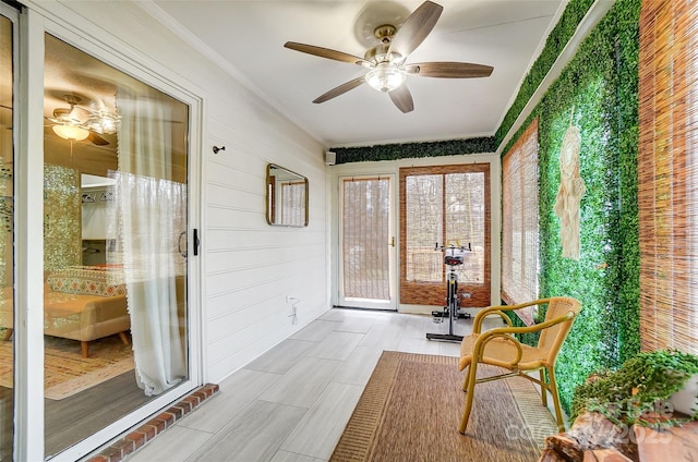 sunroom / solarium featuring ceiling fan