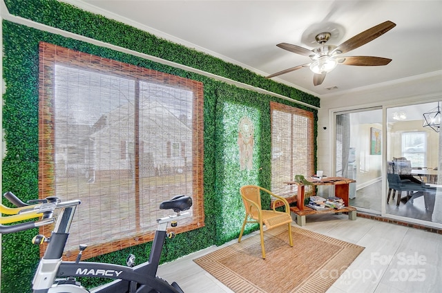 sunroom / solarium with ceiling fan with notable chandelier