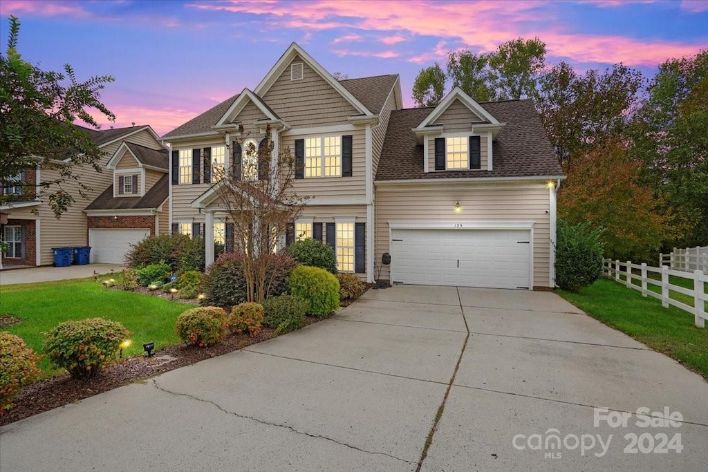 view of front of property with a lawn and a garage