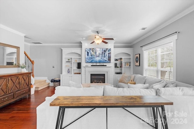 living room featuring dark hardwood / wood-style floors, ceiling fan, and ornamental molding