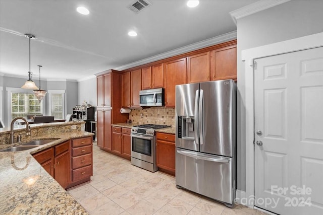 kitchen featuring light stone countertops, sink, hanging light fixtures, stainless steel appliances, and crown molding